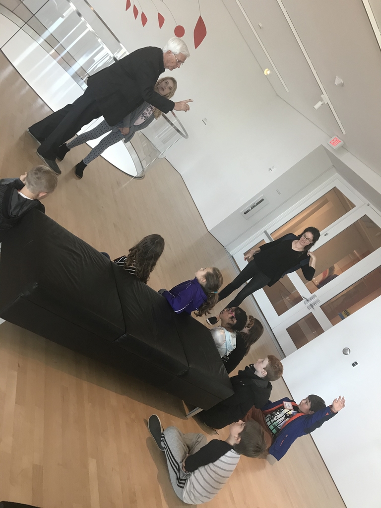Our docent connecting our concert piece we listened to earlier with pieces of art at the Milwaukee Art Museum